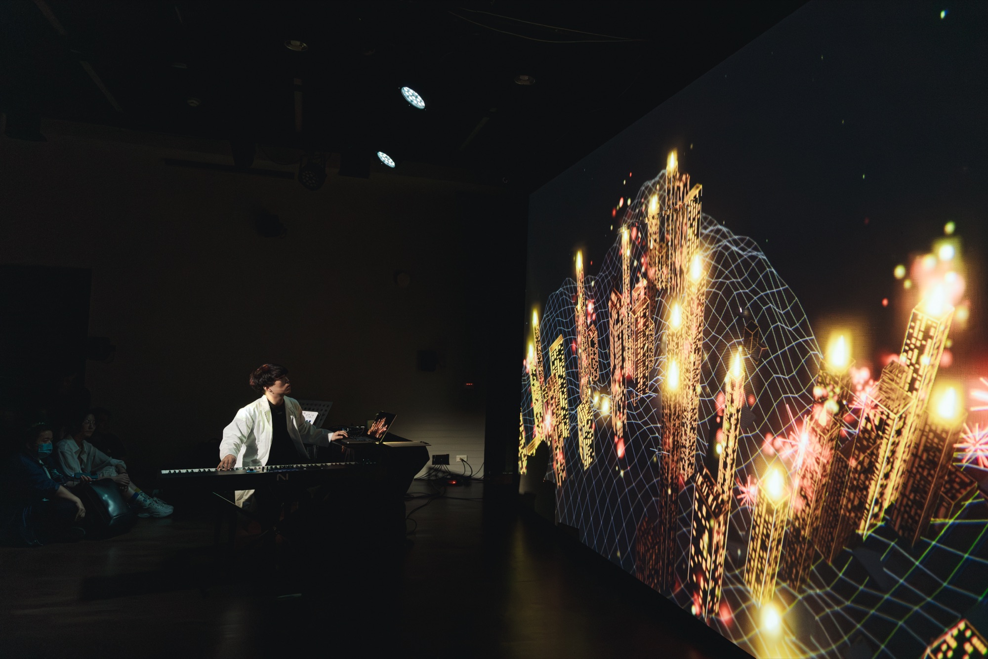 Che-Yu Wu performs at the piano beside a projection of a generative city